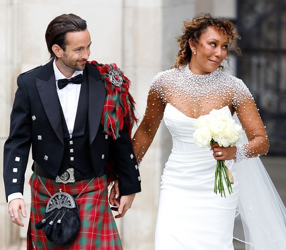 LONDON, UNITED KINGDOM - JULY 05: (EMBARGOED FOR PUBLICATION IN UK NEWSPAPERS UNTIL 24 HOURS AFTER CREATE DATE AND TIME) Rory McPhee and Mel B depart following their wedding in the OBE (Order of the B ...