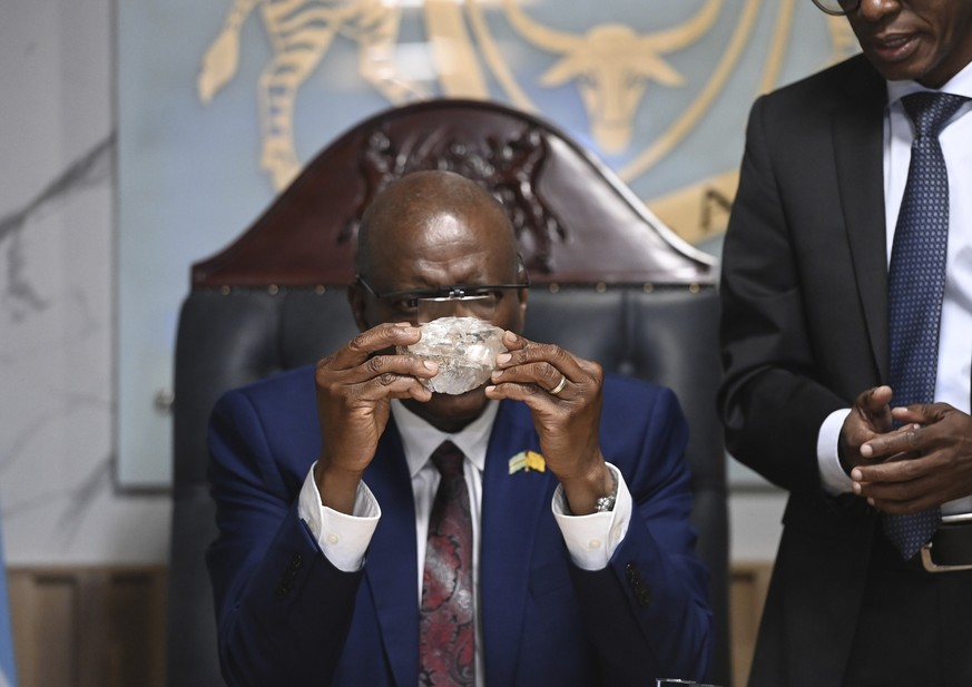 Botswana&#039;s President Mokgweetsi Masisi holds the 2,492-carat diamond that was unearthed at one of its mines and will be put on show, Thursday, Aug. 22, 2024, in Gaborone. (AP Photo)