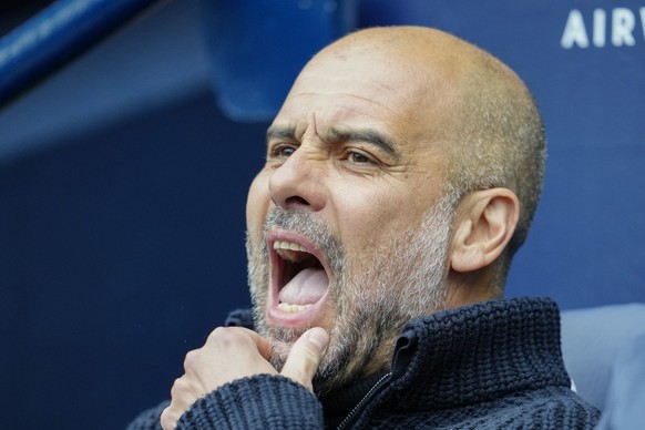 Manchester City&#039;s head coach Pep Guardiola sits on the bench prior to the English Premier League soccer match between Manchester City and Liverpool at Etihad stadium in Manchester, England, Satur ...