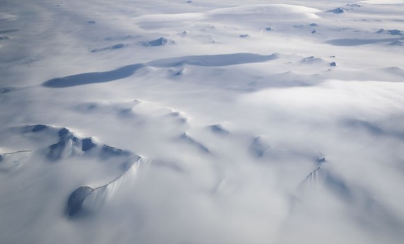 UNSPECIFIED, ANTARCTICA - NOVEMBER 04: Mountains peek through land ice as seen from NASA&#039;s Operation IceBridge research aircraft in the Antarctic Peninsula region, on November 4, 2017, above Anta ...