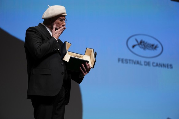 John Travolta holds his honorary Palme d'Or during the 79th international film festival, Cannes, southern France, Friday, May 15, 2026. (Photo by Scott A Garfitt/Invision/AP)
John Travolta