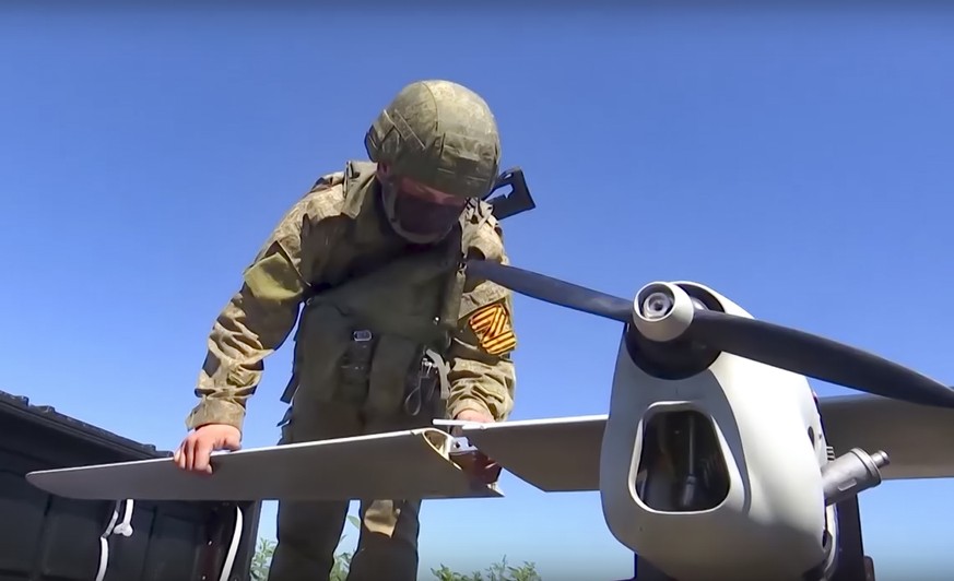 This handout photo taken from video released by Russian Defense Ministry Press Service on Monday, Aug. 8, 2022, shows a Russian serviceman preparing a Orlan-10 reconnaissance drone to launch at an und ...