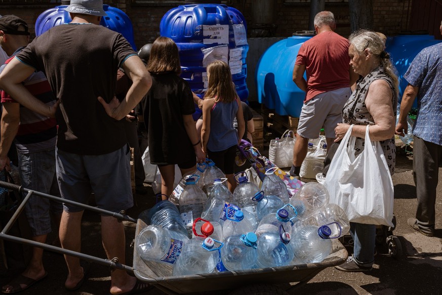 NIKOPOL, UKRAINE - JULY 3: Locals get water from a distribution point as water shortage continues for several weeks in Nikopol, Ukraine on July 3, 2023. Nikopol under a nuclear threat as the city is w ...