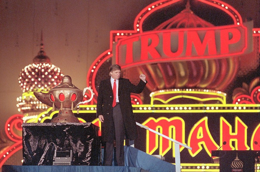 (Original Caption) Atlantic City, New Jersey: Donald Trump raises his fist in a salute as he presides over opening ceremonies of the formal opening of his Taj Mahal, which he calls the 8th wonder of t ...