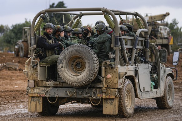 Israeli soldiers move near the border with the Gaza Strip, southern Israel, Monday, Nov. 27, 2023. on the fourth day of a temporary cease-fire between Israel and Hamas. (AP Photo/Ohad Zwigenberg)