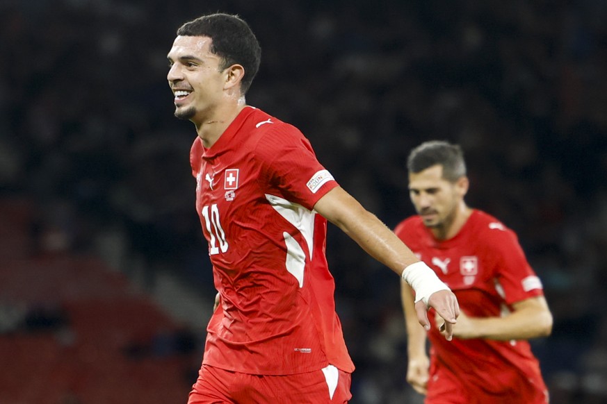 Switzerland's Zeki Amdouni, left, and Switzerland's Remo Freuler, right, celebrate the third goal during the UEFA Nations League soccer match between Scotland and Switzerland at the Hampden  ...