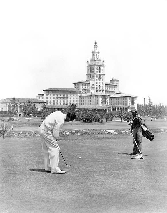 1940s MAN GOLFING PUTTING ON GREEN WITH CADDY AT BILTMORE HOTEL MIAMI, FLORIDA (Photo by H. Armstrong Roberts/ClassicStock/Getty Images)