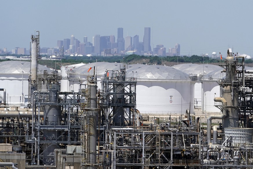 FILE - In this Thursday, April 30, 2020, photo storage tanks at a refinery along the Houston Ship Channel are seen with downtown Houston, USA, in the background. The International Energy Agency said W ...