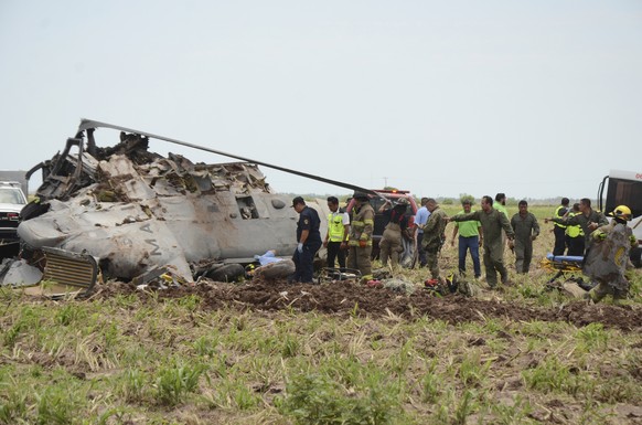 Emergency personnel work next to a navy Blackhawk helicopter crashed after supporting those who conducted the capture of drug lord Rafael Caro Quintero, near Los Mochis, Sinaloa state, Mexico, Friday, ...