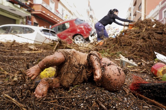 A dummy is photographed after being swept away by floods in Valencia, Spain, Wednesday, Oct. 30, 2024. (AP Photo/Alberto Saiz)