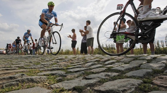 In this Tuesday July 6, 2010 file photo riders pass a cobblestone section during the third stage of the Tour de France cycling race over 213 kilometers (132.4 miles) with start in Wanze, Belgium and f ...