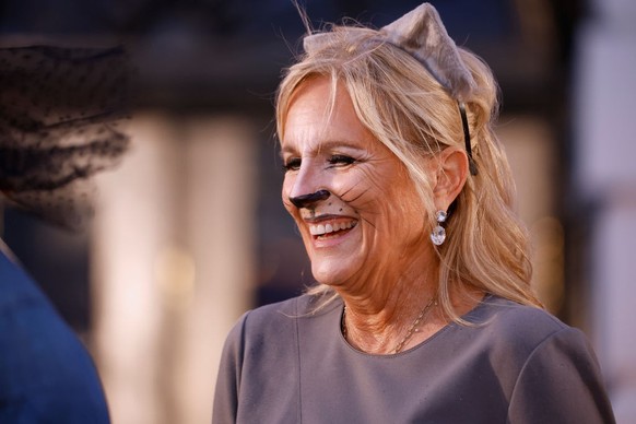 WASHINGTON, DC - OCTOBER 30: U.S. first lady Jill Biden wears cat ears and makeup while handing out books during a Halloween trick-or-treat event on the South Lawn of the White House on October 30, 20 ...