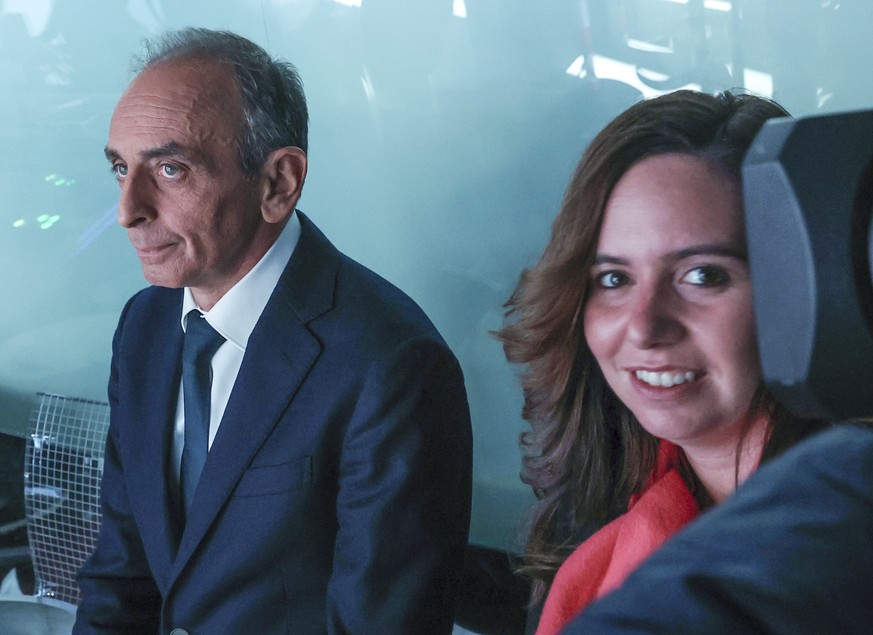 French far-right presidential candidate Eric Zemmour, left, waiting for his turn for a TV interviews with event adviser Sarah Knafo at French TV station TF1 in Boulogne-Billancourt, outside Paris, Tue ...