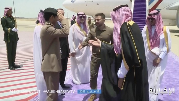 This video grab shows Ukrainian President Volodymyr Zelenskyy, center, arriving at the airport in Jeddah, Saudi Arabia, Friday May 19, 2023. Zelenskyy announced Friday he has kicked off a visit to Sau ...