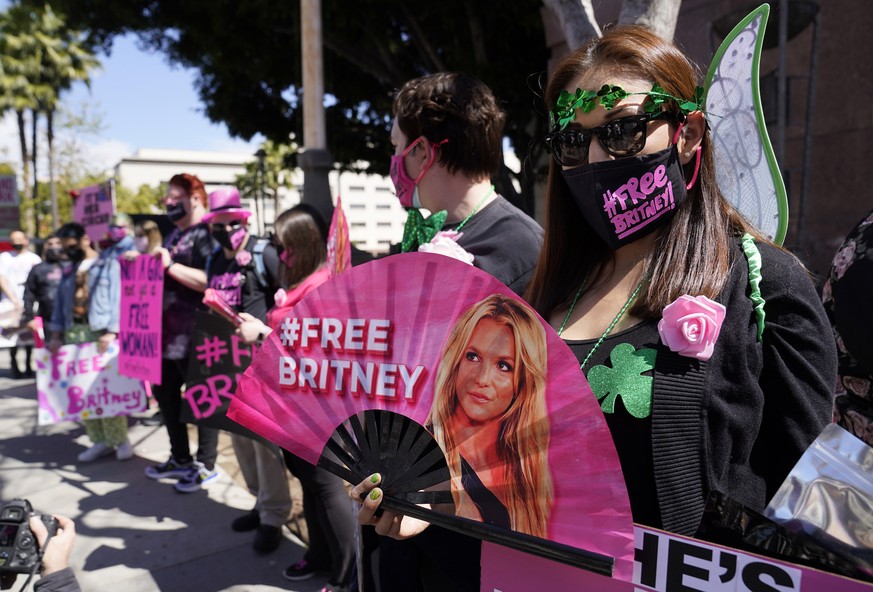 FILE - Britney Spears supporter Kiki Norberto holds a hand fan outside a court hearing concerning the pop singer&#039;s conservatorship on March 17, 2021, in Los Angeles. When Spears speaks to a judge ...