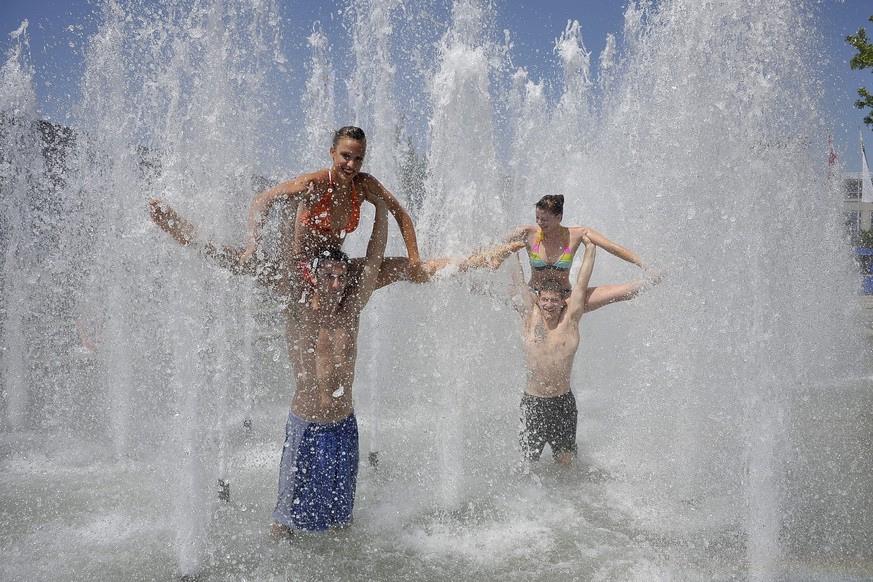 Swiss gymnasts from Ticino play in a fountain during the 14th World Gymnaestrada in Lausanne, Switzerland, Tuesday, July 12, 2011. Some 20,000 participants from 55 nations participate in this event wh ...