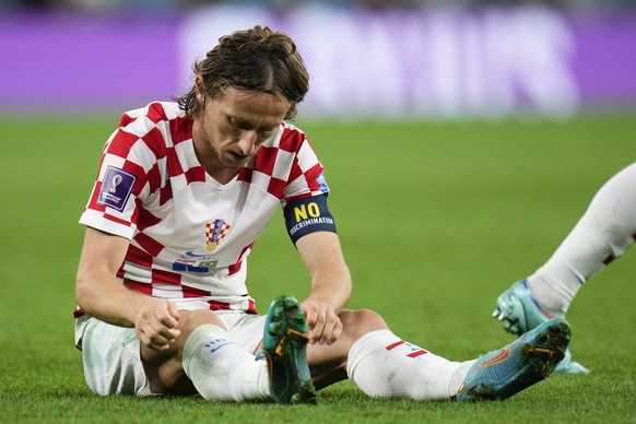 Croatia's Luka Modric sits on the pitch after falling during the World Cup quarterfinal soccer match between Croatia and Brazil, at the Education City Stadium in Al Rayyan, Qatar, Friday, Dec. 9, 2022 ...
