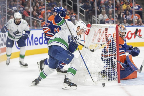 Vancouver Canucks&#039; Pius Suter, looks for a shot against Edmonton Oilers goalie Stuart Skinner (74) during first-period preseason NHL hockey game action in Calgary, Alberta, Monday, Sept. 30, 2024 ...