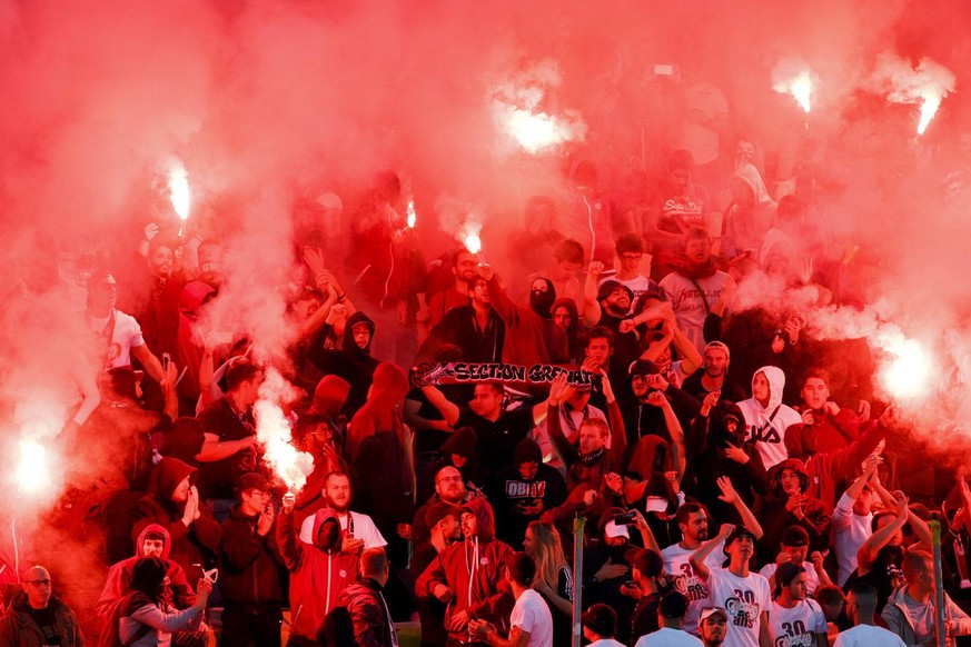 Servette&#039;s supporters light smoke flares, during the Challenge League soccer match of Swiss Championship between Servette FC and FC Lausanne-Sport, at the Stade de Geneve stadium, in Geneva, Swit ...