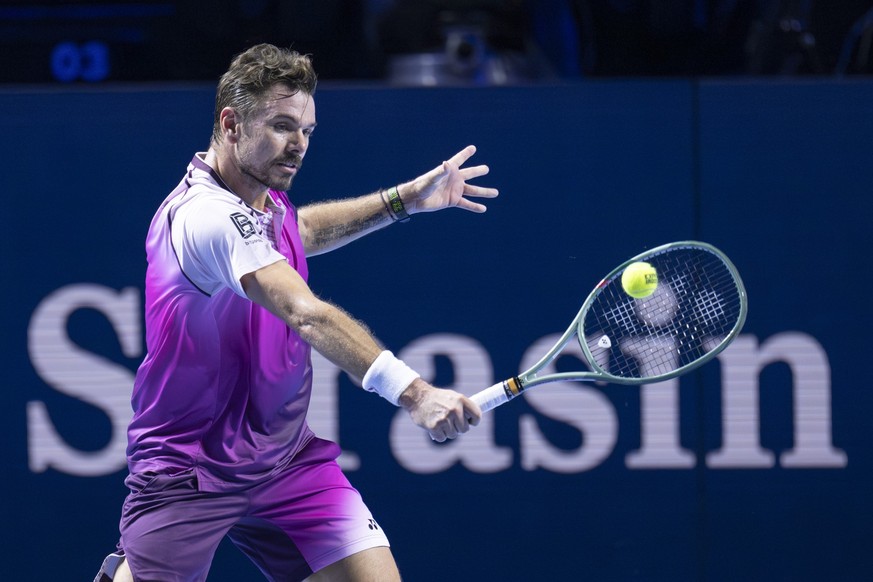 Switzerland&#039;s Stan Wawrinka returns a ball to Serbia&#039;s Miomir Kecmanovic during their first round match at the Swiss Indoors tennis tournament at the St. Jakobshalle in Basel, Switzerland, o ...