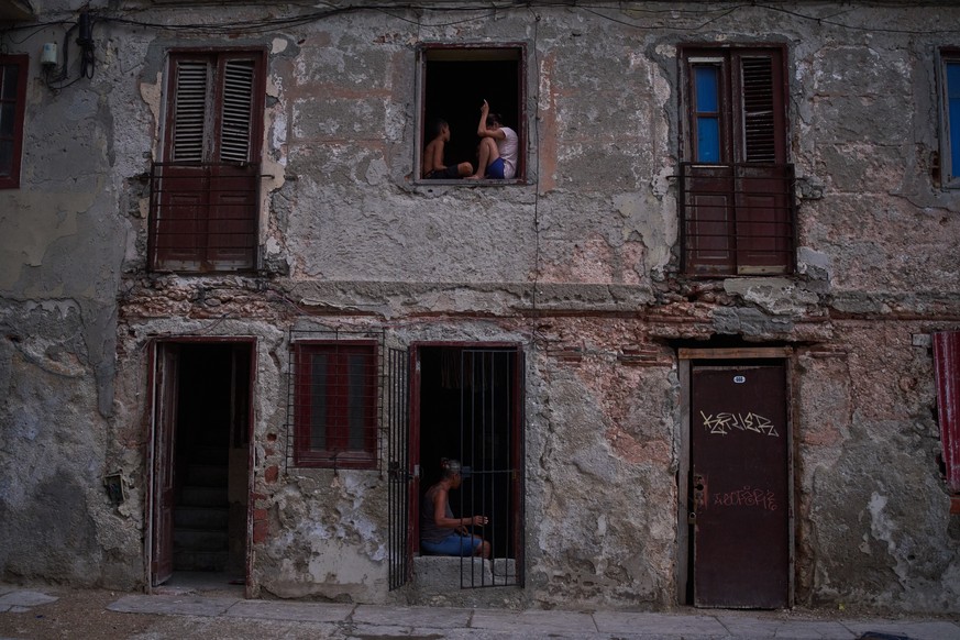 People catch the cool air from the street at their home's window during a blackout in Havana, Cuba, Friday, July 10, 2026. (AP Photo/Ramon Espinosa)
Cuba Blackout