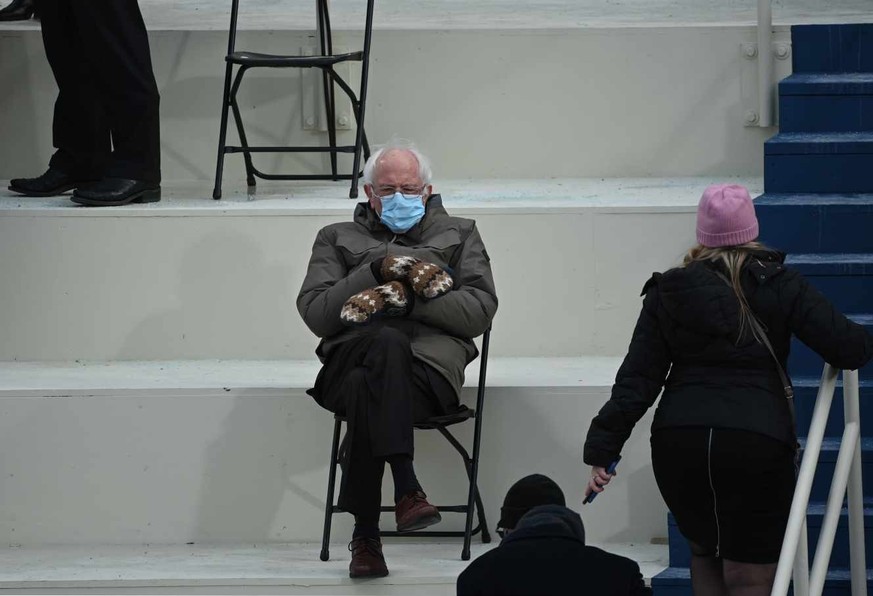 TOPSHOT - Former presidential candidate, Senator Bernie Sanders (D-Vermont) sits in the bleachers on Capitol Hill before Joe Biden is sworn in as the 46th US President on January 20, 2021, at the US C ...