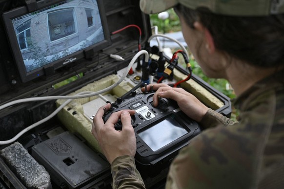 Drone pilot with callsign Rubik, 22, from the Reconnaissance Company &quot;Only Wars&quot; of the Ukrainian 3rd Army Corps controls a FPV drone during a training flight in an undisclosed location, in  ...