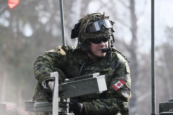 epa10549207 Canadian Army serviceman of NATO enhanced forward battlegroup Latvia in light armoured vehicles LAV6 during the military exercise &#039;Crystal Arrow 2023&#039; at the Adazi military train ...