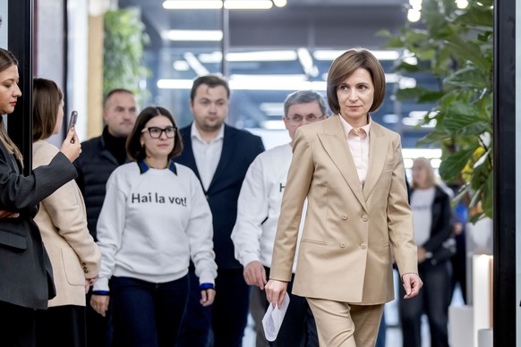 epa11672113 President of Moldova Maia Sandu (R) arrives to her press briefing in Chisinau, Moldova, early 21 October 2024. Moldova held a presidential election and a referendum on whether to enshrine  ...