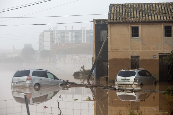 epa11692342 Damaged vehicles are seen partially submerged in the flood-hit municipality of Sedavi, in the province of Valencia, eastern Spain, 30 October 2024. The intense rainfall impacting the easte ...
