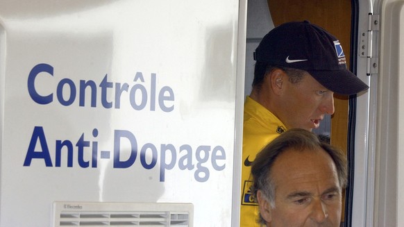 FILE - In this July 24, 2002, file photo, cyclist Lance Armstrong walks out of the Tour de France&#039;s anti-doping control bus after the 16th stage of the Tour de France cycling race between Les Deu ...