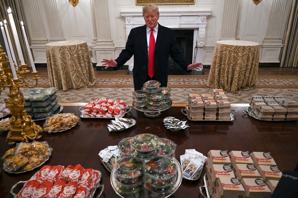 FILE - President Donald Trump talks to reporters about the table full of fast food in the State Dining Room of the White House in Washington, Jan. 14, 2019, for the reception for the Clemson Tigers. ( ...