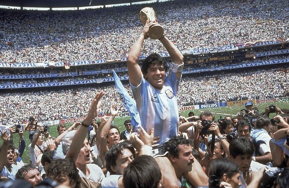 FILE - Diego Maradona, holds up the trophy, after Argentina beat West Germany 3-2 in the World Cup soccer final match, at the Atzeca Stadium, in Mexico City on June 29, 1986. (AP Photo/Carlo Fumagalli ...