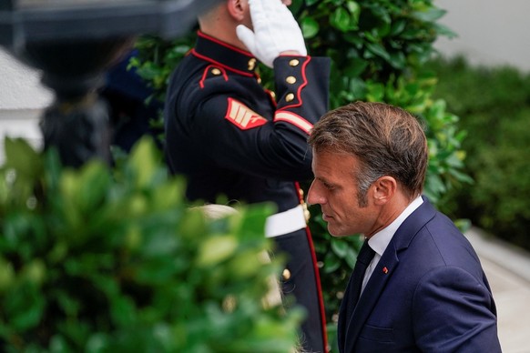 U.S. Chief of Protocol Monica Crowley walks with French President Emmanuel Macron as he arrives at the White House amid negotiations to end the Russian war in Ukraine, in Washington, D.C., U.S., Augus ...