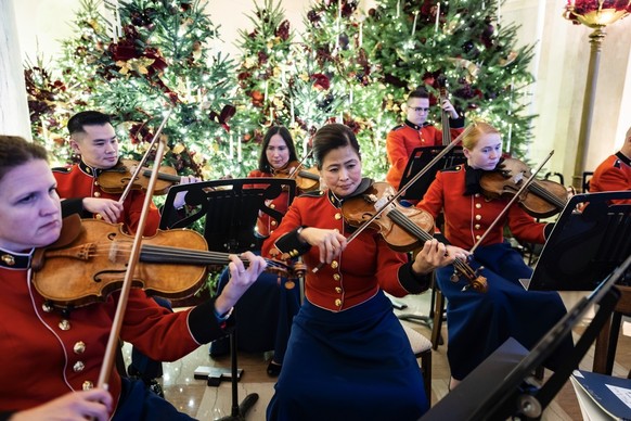 epa12562185 Members of the President&#039;s Own United States Marine Band perform in the Center Hall of the White House during a holiday decoration tour for the media in Washington, DC, USA, 01 Decemb ...