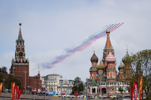 Russian Air Force Su-25 jets fly over Red Square leaving trails of smoke in the colours of the Russian national flag during the Victory Day military parade in Moscow, Russia, Thursday, May 9, 2024, ma ...