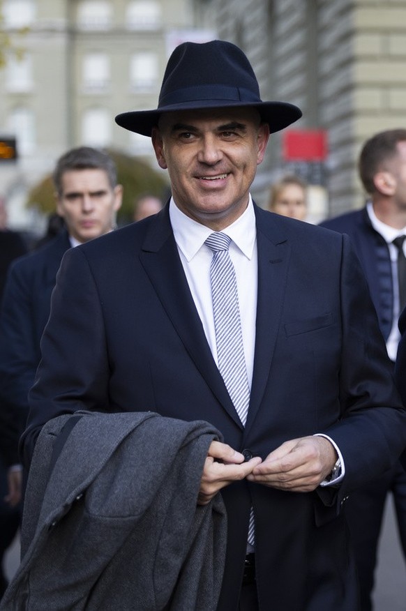 Swiss Federal President Alain Berset, left, and French President Emanuel Macron discuss on their way to the delegation meeting in front of the Federal Palace, the Swiss Parliament building, in Bern, S ...