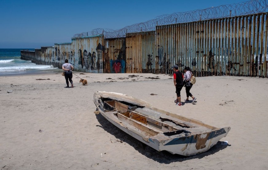 TIJUANA, MEXICO - JUNE 20: People walk along the US-Mexico border as workers construct a new wall along the southernmost part, seen from Tijuana, Mexico on June 20, 2023 in Tijuana, Mexico. Friendship ...
