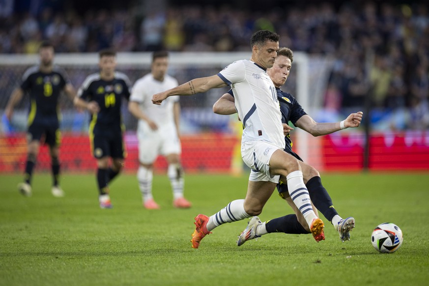 Switzerland&#039;s Granit Xhaka, left, in action against $Scotland&#039;s Scott McTominay, right, during a Group A match between Scotland and Switzerland at the Euro 2024 soccer tournament in Cologne, ...