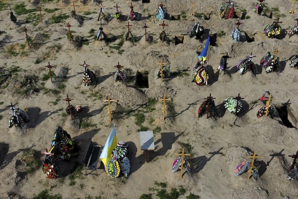 FILE - Tombs of people who died after Russia invasion are seen in Bucha cemetery, outskirts of Kyiv, Ukraine, on May 24, 2022. By ending 77 years of almost uninterrupted peace in Europe, war in Ukrain ...