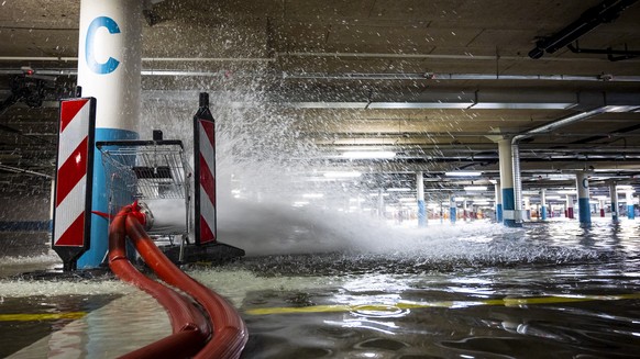 epa09350019 The lower second floor of the Maladiere Centre parking lot, which includes the shopping center and the Neuchatel Xamax stadium, is flooded in order to ballast the building and compensate f ...