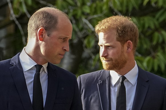 FILE - Britain&#039;s Prince William and Britain&#039;s Prince Harry walk beside each other after viewing the floral tributes for the late Queen Elizabeth II outside Windsor Castle, in Windsor, Englan ...