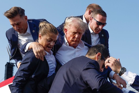 BUTLER, PENNSYLVANIA - JULY 13: Republican presidential candidate former President Donald Trump is rushed offstage by U.S. Secret Service agents after being grazed by a bullet during a rally on July 1 ...