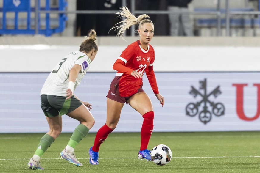 Northern Ireland's Natalie Johnson, left, fights for the ball with Switzerland's Alisha Lehmann, right, during the FIFA 2027 Women's World Cup League B - Group B2 qualifying soccer matc ...