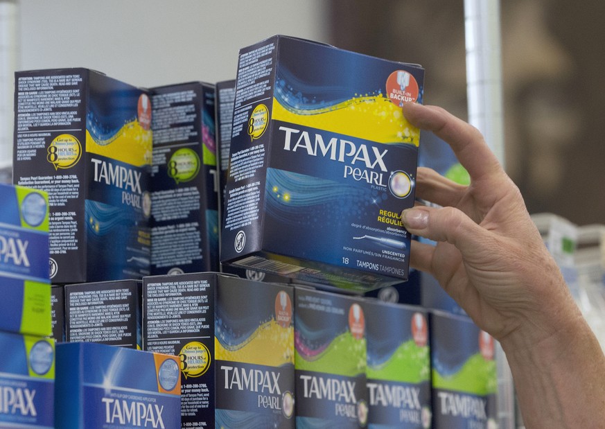 FILE - In this June 22, 2016, file photo, Tammy Compton restocks tampons at Compton&#039;s Market, in Sacramento, Calif. California public schools and colleges would have to stock their restrooms with ...