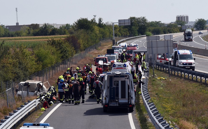 epa10118502 Emergency services at the scene where at least three people were killed and several seriously injured after an accident on the A6 near the Kittsee border crossing, Austria, 13 August 2022. ...