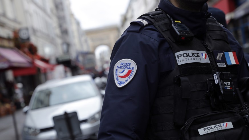 epa10377081 A French Police officer secures the perimeter on &#039;Rue d&#039;Enghien&#039; following a shooting incident near a Kurdish cultural centre in Paris, France, 23 December 2022. The Paris P ...