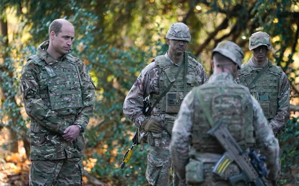 SALISBURY, ENGLAND - NOVEMBER 23: Prince William, Prince of Wales, Colonel-in-Chief, 1st Battalion Mercian Regiment (L) listens to a briefing ahead of an attack exercise during a visit to the regiment ...