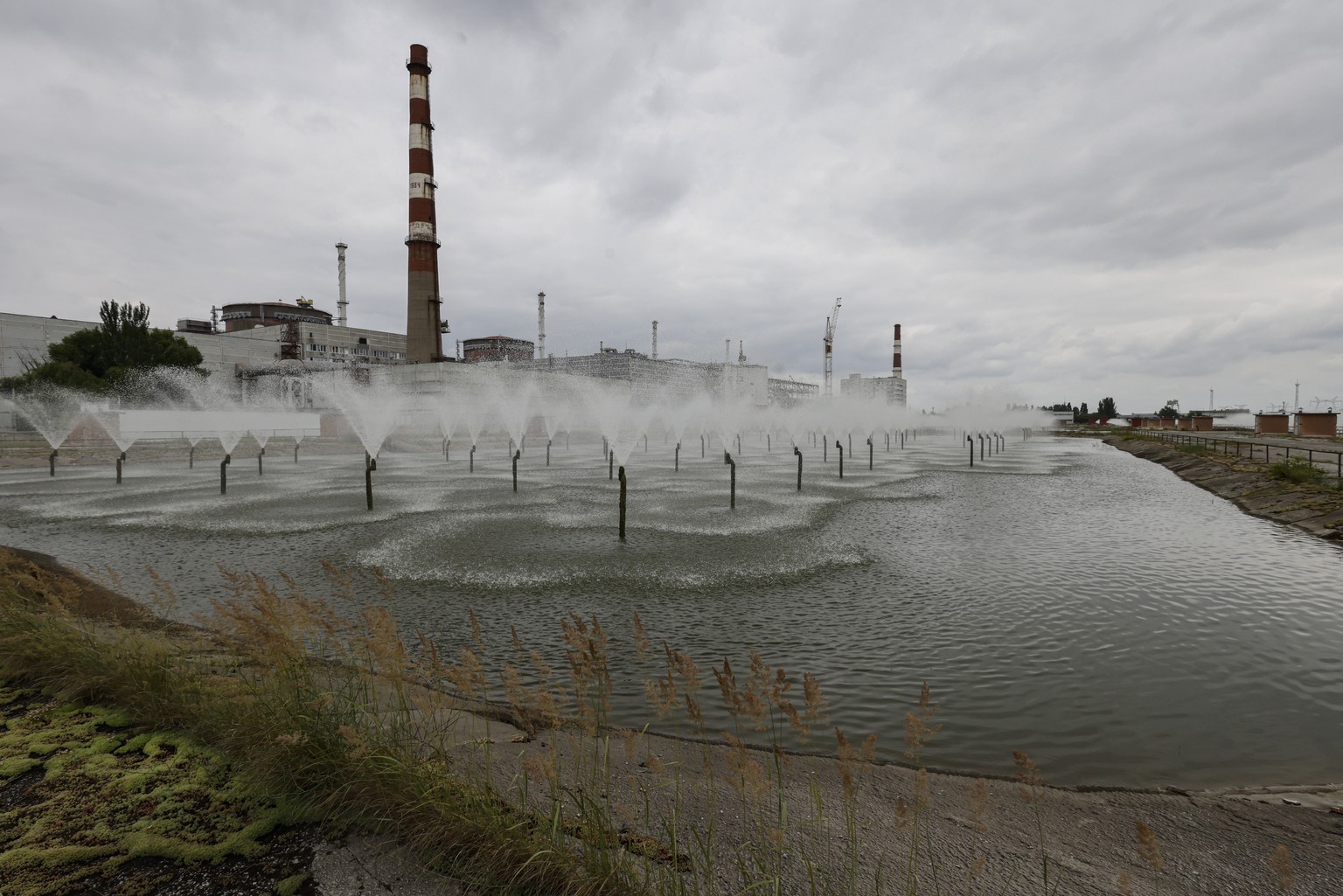epa10692571 A picture taken during a visit to Enerhodar organised by the Russian Defence ministry shows the cooling systems of the Zaporizhzhia Nuclear Power Plant in Enerhodar, southeastern Ukraine,  ...