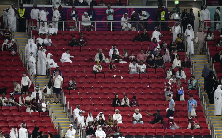 People leaving before the final whistle during the World Cup, group A soccer match between Qatar and Ecuador at the Al Bayt Stadium in Al Khor, Sunday, Nov. 20, 2022. (AP Photo/Natacha Pisarenko)